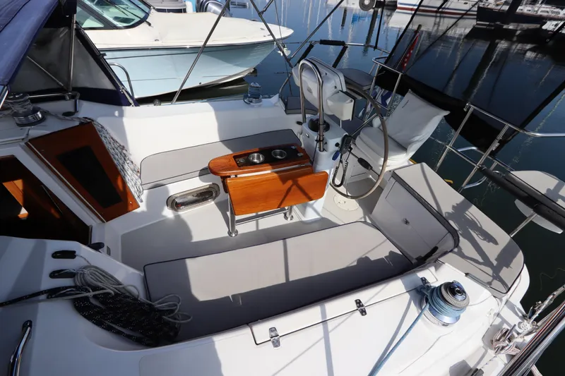 Slide: The Image of Cockpit of 2011 Catalina 355 sailboat with seating and steering wheel in marina. - 15
