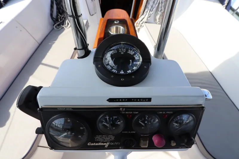Slide: The Image of Cockpit controls of a 2011 Catalina 355 yacht, featuring navigation instruments and gauges. - 18