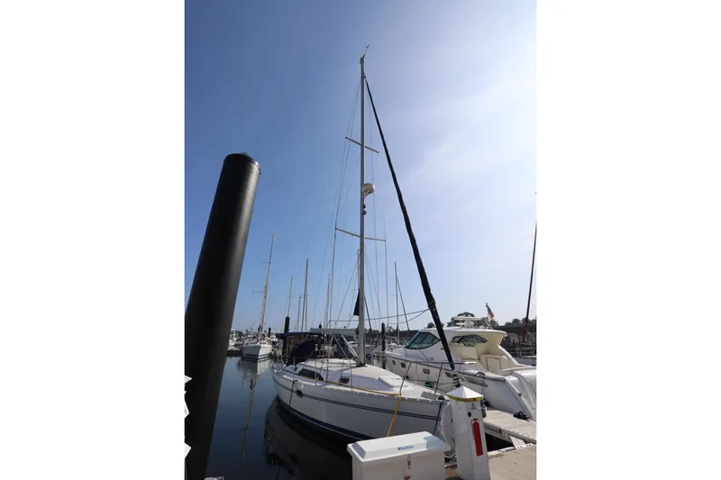 Slide: The Image of 2011 Catalina 355 sailboat docked at marina under clear blue sky. - 2