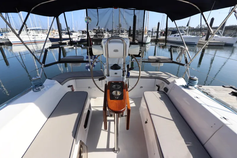 Slide: The Image of Cockpit of 2011 Catalina 355 sailboat docked at marina, featuring comfortable seating and steering wheel. - 20