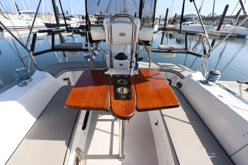 Slide: The Image of Cockpit of 2011 Catalina 355 sailboat with wooden table and marina view. - 21