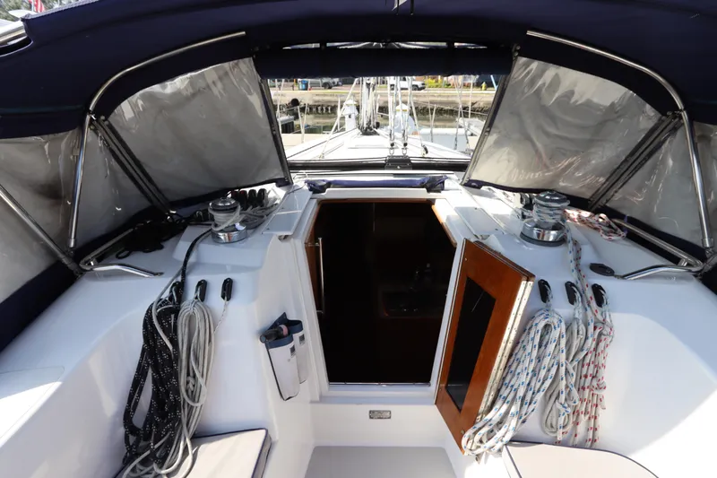 Slide: The Image of Cockpit of 2011 Catalina 355 sailboat with ropes and open cabin door. - 22