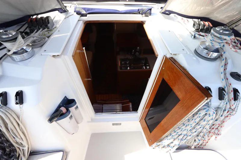 Slide: The Image of Cockpit view of a 2011 Catalina 355 sailboat, featuring ropes and winches. - 27