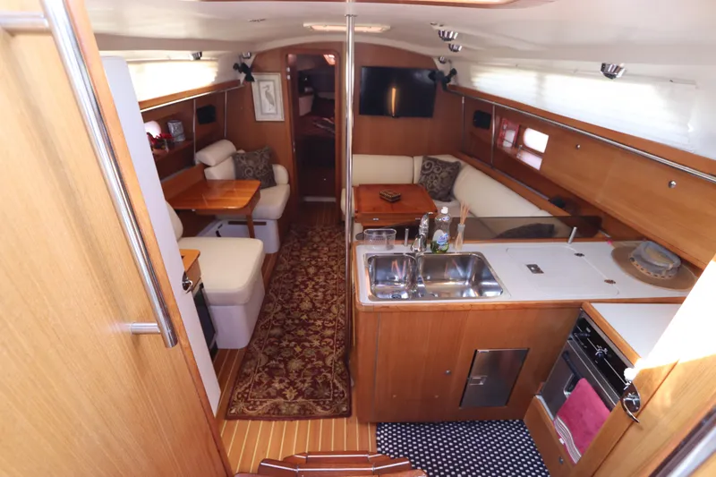 Slide: The Image of Interior of 2011 Catalina 355 sailboat with cozy seating and modern kitchen amenities. - 28