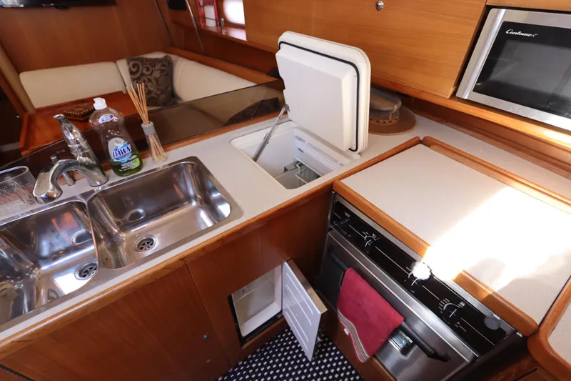 Slide: The Image of 2011 Catalina 355 yacht kitchen with sink, stove, and microwave. - 31