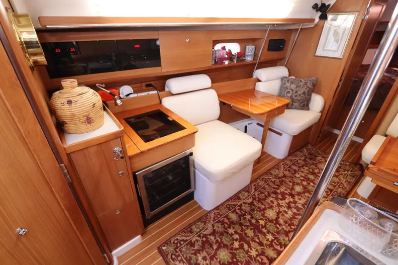 Slide: The Image of Interior of 2011 Catalina 355 sailboat with cozy seating and wooden cabinetry. - 34