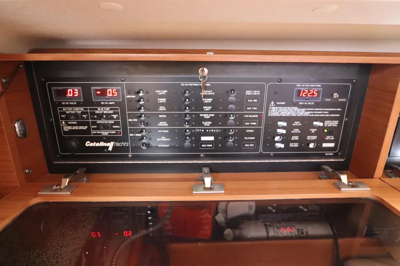 Slide: The Image of Control panel of a 2011 Catalina 355 yacht, featuring various switches and digital displays. - 37
