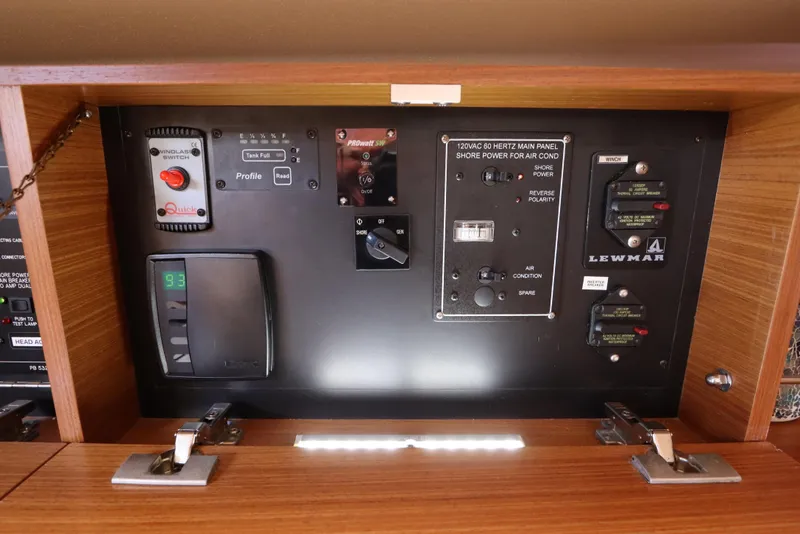 Slide: The Image of Control panel of a 2011 Catalina 355 sailboat with various switches and indicators. - 38