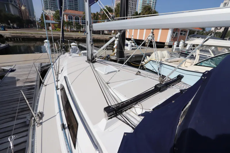 Slide: The Image of Sailboat Catalina 355, 2011 model, docked at marina with cityscape background. - 4