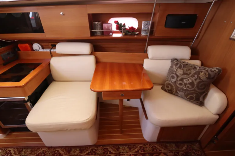 Slide: The Image of Cozy interior of 2011 Catalina 355 sailboat with wooden table and cushioned seating. - 43