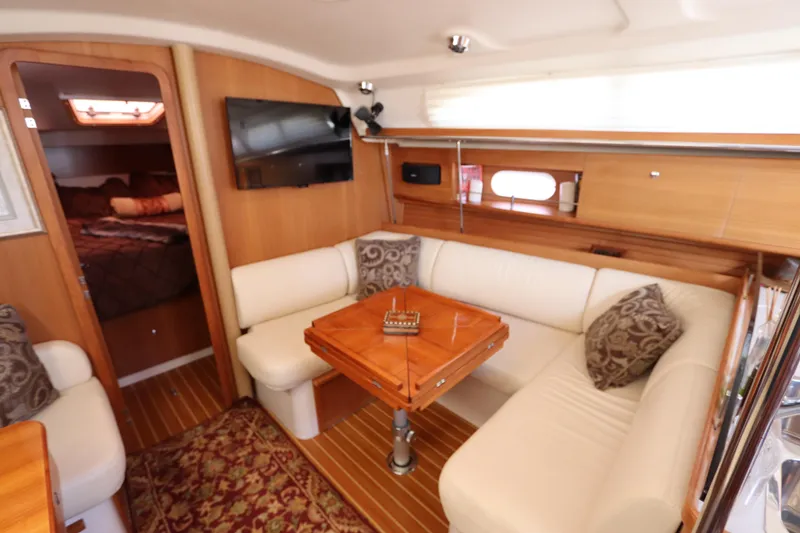 Slide: The Image of Luxurious interior of 2011 Catalina 355 sailboat with cozy seating and elegant wood finish. - 44