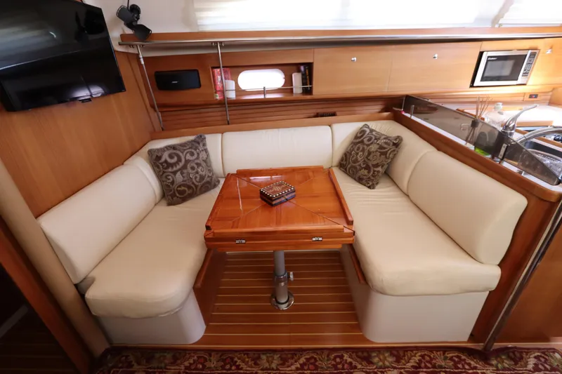 Slide: The Image of Luxurious interior of 2011 Catalina 355 yacht with cozy seating and elegant wood finish. - 45