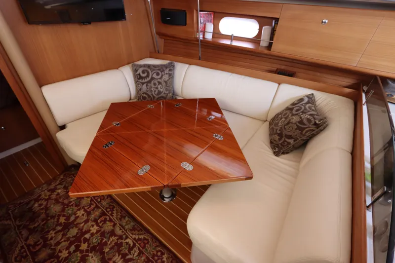 Slide: The Image of Luxurious interior of 2011 Catalina 355 yacht with elegant wood table and plush seating. - 46