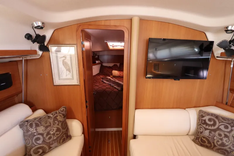 Slide: The Image of Interior of 2011 Catalina 355 yacht with cozy seating, wall art, and mounted TV. - 47