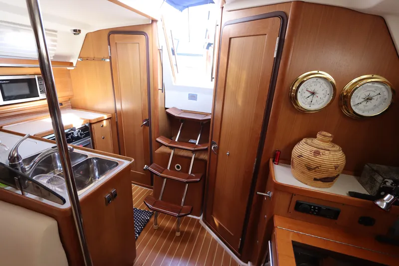 Slide: The Image of Interior of 2011 Catalina 355 sailboat with wooden cabinetry and nautical instruments. - 49