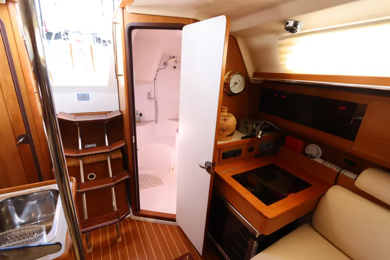 Slide: The Image of Interior of 2011 Catalina 355 sailboat with compact kitchen and bathroom. - 50