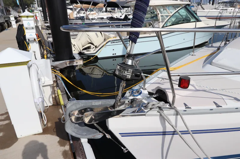 Slide: The Image of 2011 Catalina 355 sailboat docked, featuring anchor and deck details. - 6