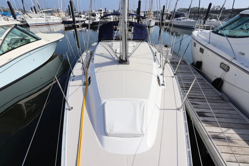 Slide: The Image of 2011 Catalina 355 sailboat docked at marina, surrounded by other boats. - 7
