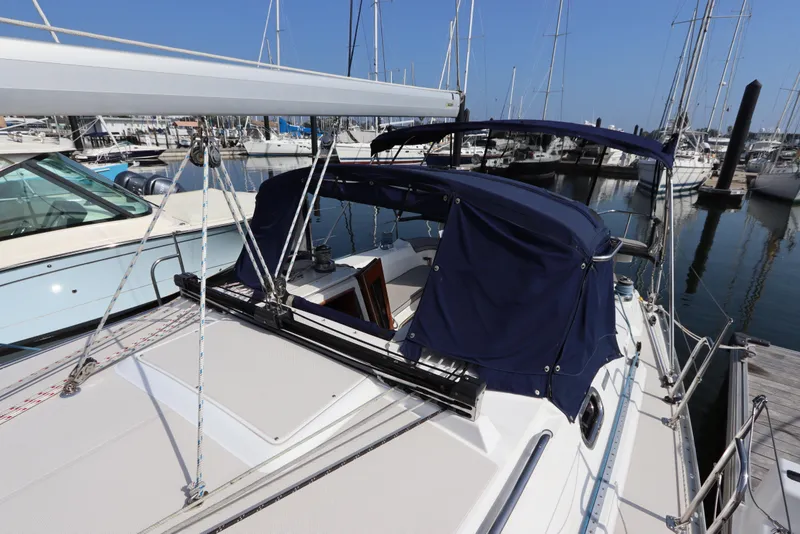 Slide: The Image of 2011 Catalina 355 sailboat docked at marina with blue canopy and rigging. - 9