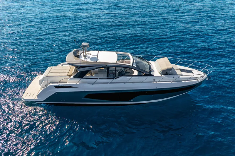 Slide: The Image of 2021 Azimut Atlantis 51 yacht cruising on clear blue ocean waters. - 12