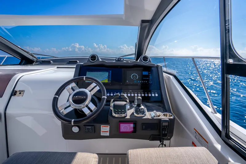 Slide: The Image of Cockpit of 2021 Azimut Atlantis 51 yacht with ocean view and modern controls. - 33