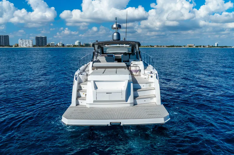 Slide: The Image of Azimut Atlantis 51 yacht, 2021 model, cruising on blue ocean near city skyline. - 5