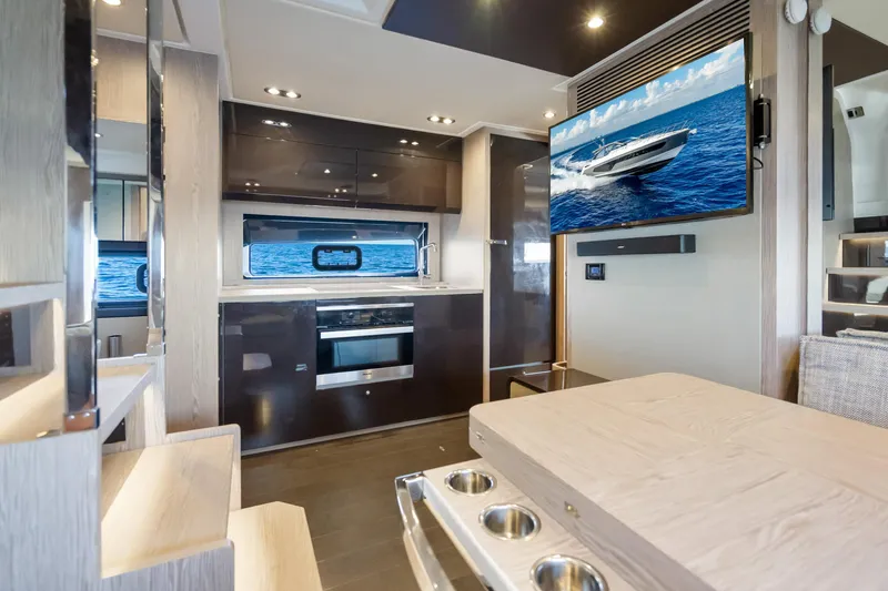 Slide: The Image of Luxurious interior of 2021 Azimut Atlantis 51 yacht with modern kitchen and TV. - 67