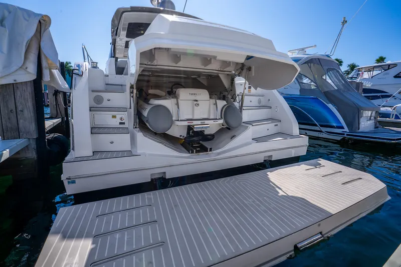 Slide: The Image of 2021 Azimut Atlantis 51 yacht with open garage and swim platform at marina. - 74