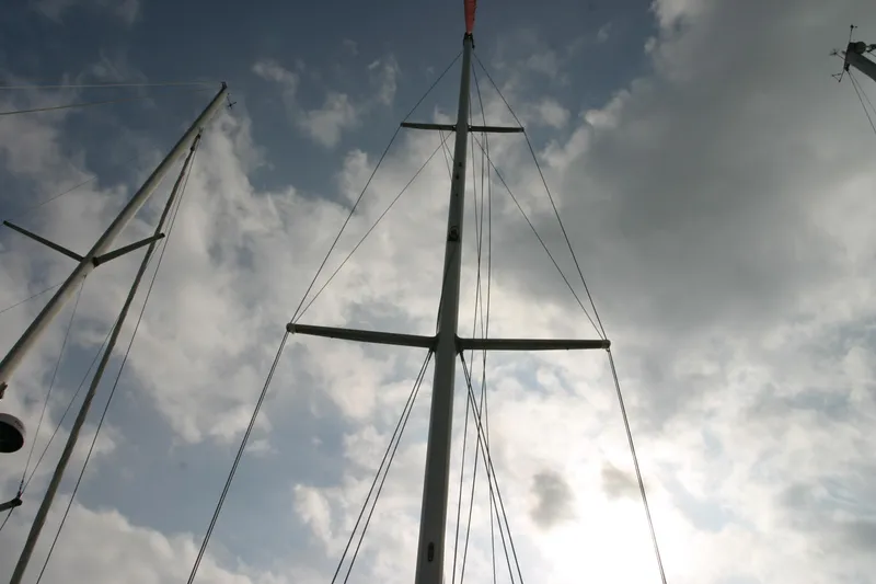 Slide: The Image of Mast of 1983 Beneteau Idylle 11.50 sailboat against cloudy sky. - 11