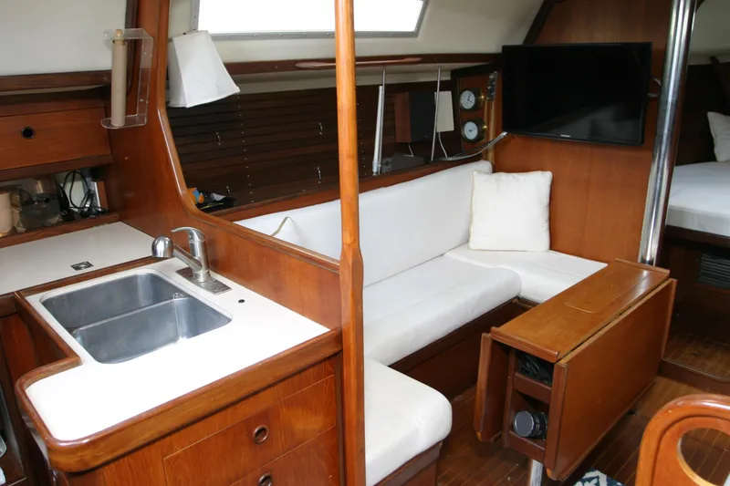 Slide: The Image of Interior of 1983 Beneteau Idylle 11.50 yacht with cozy seating and kitchenette. - 7