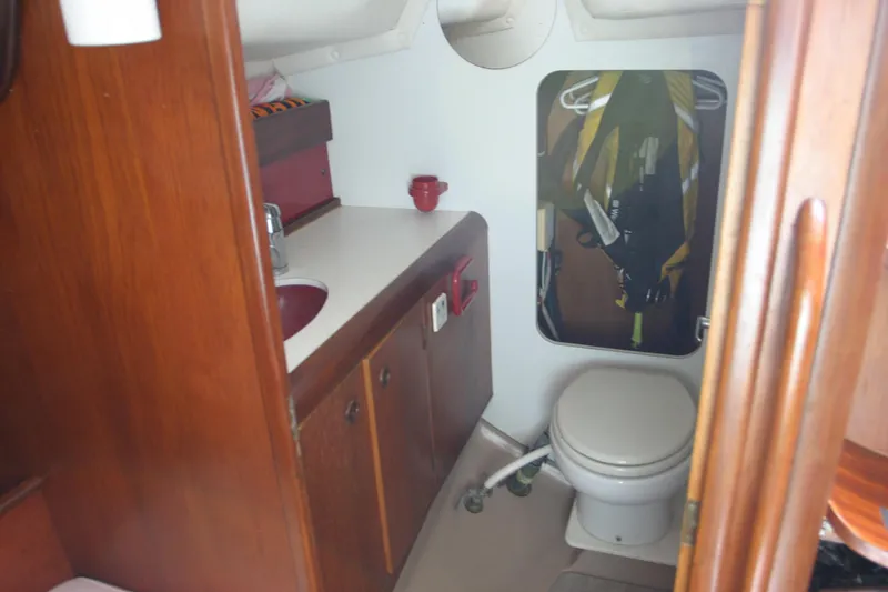 Slide: The Image of Interior of 1983 Beneteau Idylle 11.50 sailboat bathroom with wooden cabinetry. - 8
