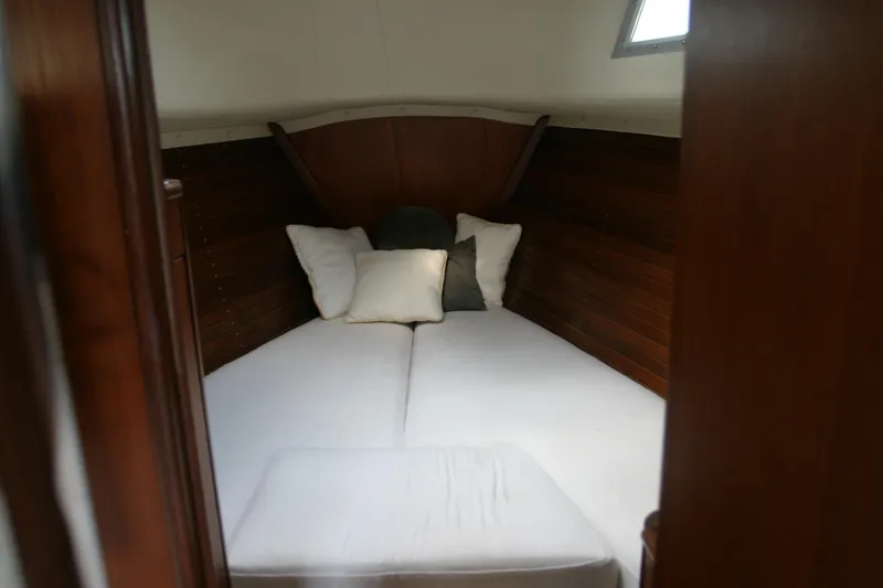 Slide: The Image of Cozy cabin interior of 1983 Beneteau Idylle 11.50 sailboat with wooden paneling. - 3