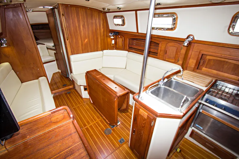 Slide: The Image of Interior of 1992 Pacific Seacraft Cutter yacht with wood finish and modern amenities. - 13