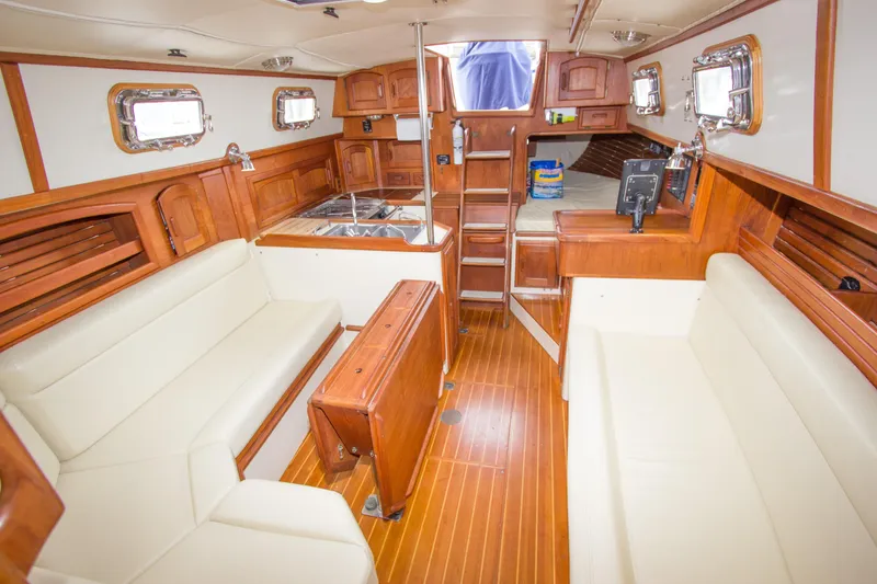 Slide: The Image of Interior of 1992 Pacific Seacraft Cutter sailboat with wooden finishes and white seating. - 14