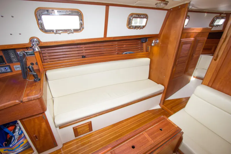 Slide: The Image of Interior of 1992 Pacific Seacraft Cutter sailboat with wooden finish and white seating. - 16