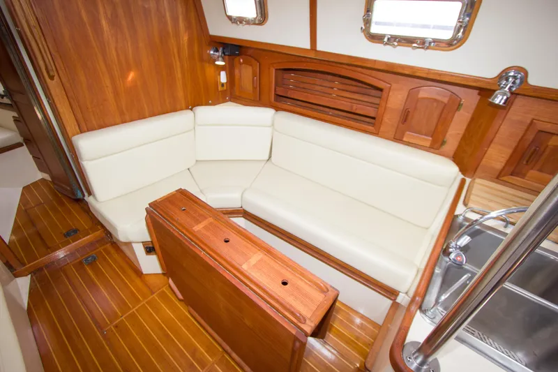 Slide: The Image of Interior of 1992 Pacific Seacraft Cutter with wooden finish and cream seating. - 17