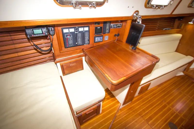 Slide: The Image of 1992 Pacific Seacraft Cutter interior with navigation station and wooden furnishings. - 19
