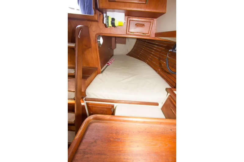 Slide: The Image of Cozy cabin interior of 1992 Pacific Seacraft Cutter with wooden finish and comfortable bedding. - 21