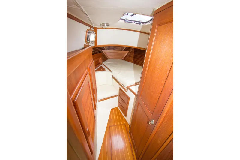 Slide: The Image of 1992 Pacific Seacraft Cutter interior with wooden cabinetry and cozy sleeping area. - 23