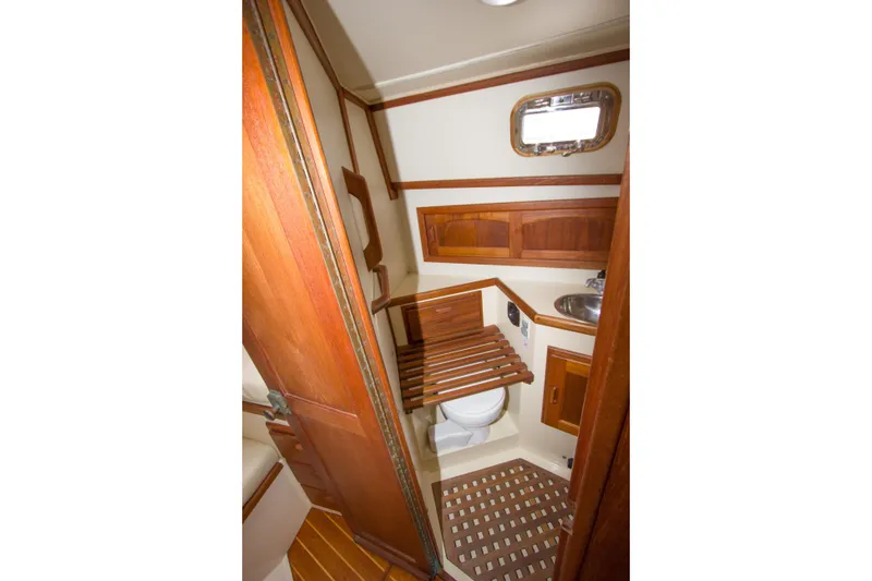 Slide: The Image of 1992 Pacific Seacraft Cutter yacht bathroom with wooden accents and compact design. - 24