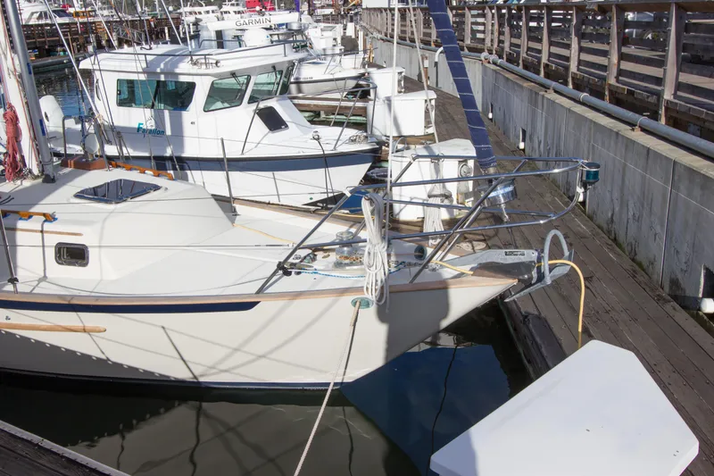 Slide: The Image of 1992 Pacific Seacraft 37 sloop docked at marina, surrounded by other boats. - 28