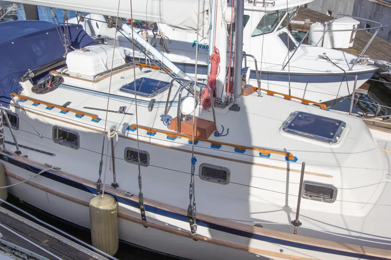 Slide: The Image of 1992 Pacific Seacraft 37 sloop docked, showcasing deck and rigging details. - 29