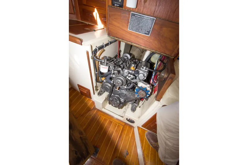 Slide: The Image of Engine compartment of a 1992 Pacific Seacraft 37 sloop, showcasing detailed mechanical components. - 32