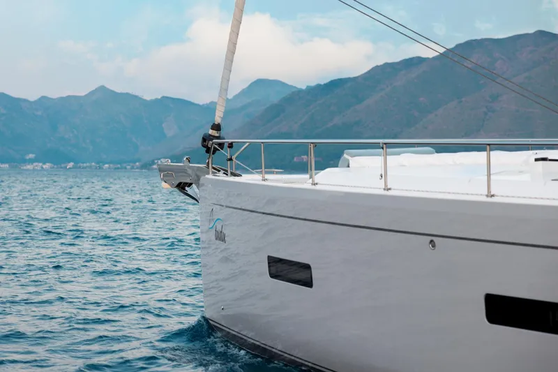 Slide: The Image of 2026 Moody 48 Deck Saloon yacht sailing near scenic mountains. - 15