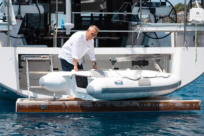 Slide: The Image of Man handling dinghy on 2026 Moody 48 deck saloon yacht platform. - 20