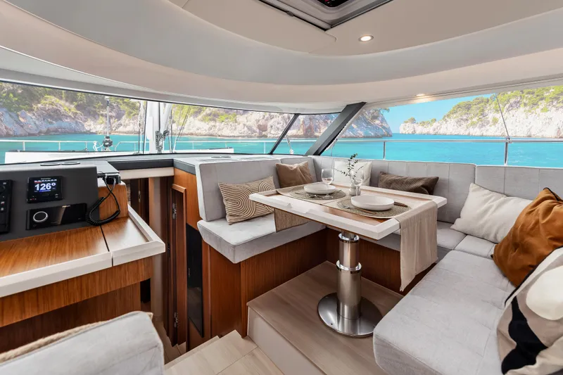 Slide: The Image of Luxurious interior of 2026 Moody 48 Deck Saloon yacht with scenic ocean view. - 23