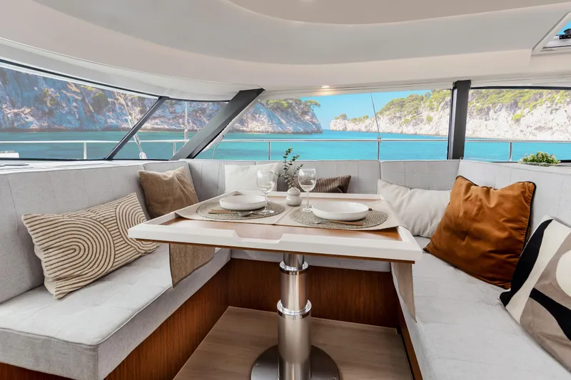 Slide: The Image of Luxurious interior of 2026 Moody 48 Deck Saloon yacht with scenic ocean view. - 24