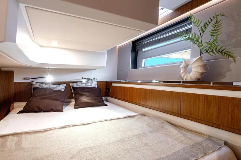 Slide: The Image of Luxurious interior of 2026 Moody 48 Deck Saloon yacht with cozy bedding and modern decor. - 26