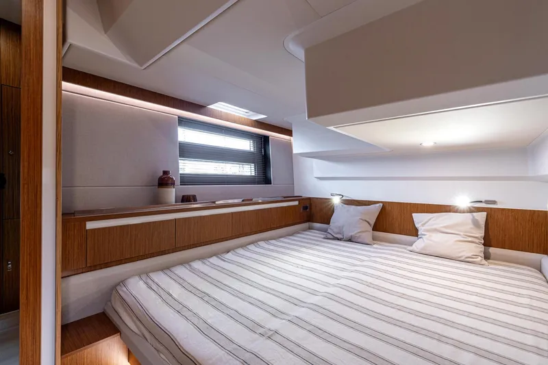 Slide: The Image of Luxurious interior of 2026 Moody 48 Deck Saloon yacht with cozy bed and modern design. - 27