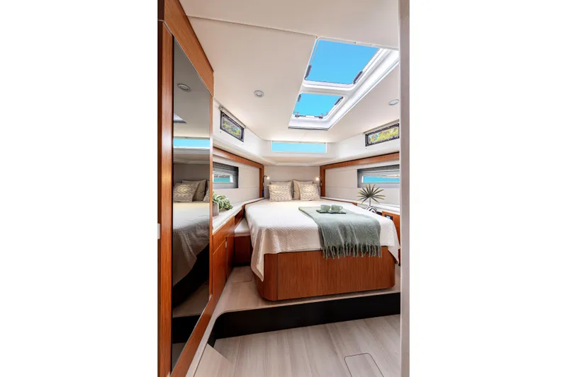 Slide: The Image of Luxurious 2026 Moody 48 Deck Saloon interior with skylights and elegant wood finishes. - 28
